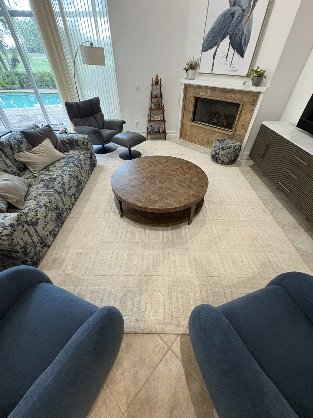 Custom area rug in a Naples living room with poolside views