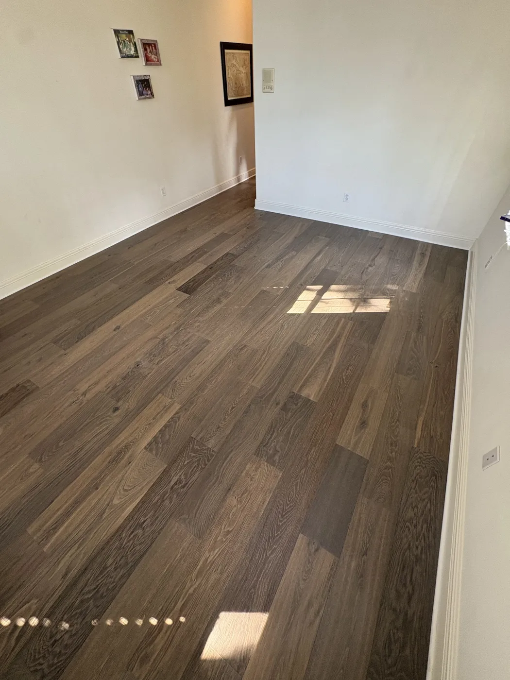 Rustic wide-plank hardwood flooring in a Naples hallway