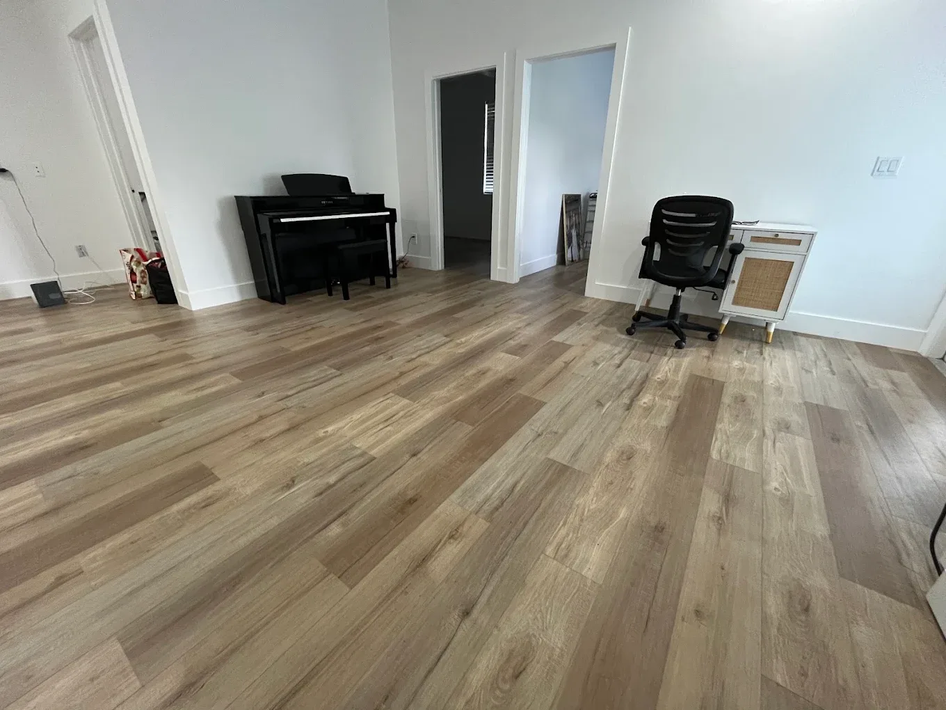 Oak-look luxury vinyl plank flooring in a Naples living room finished by Enterprise Floors