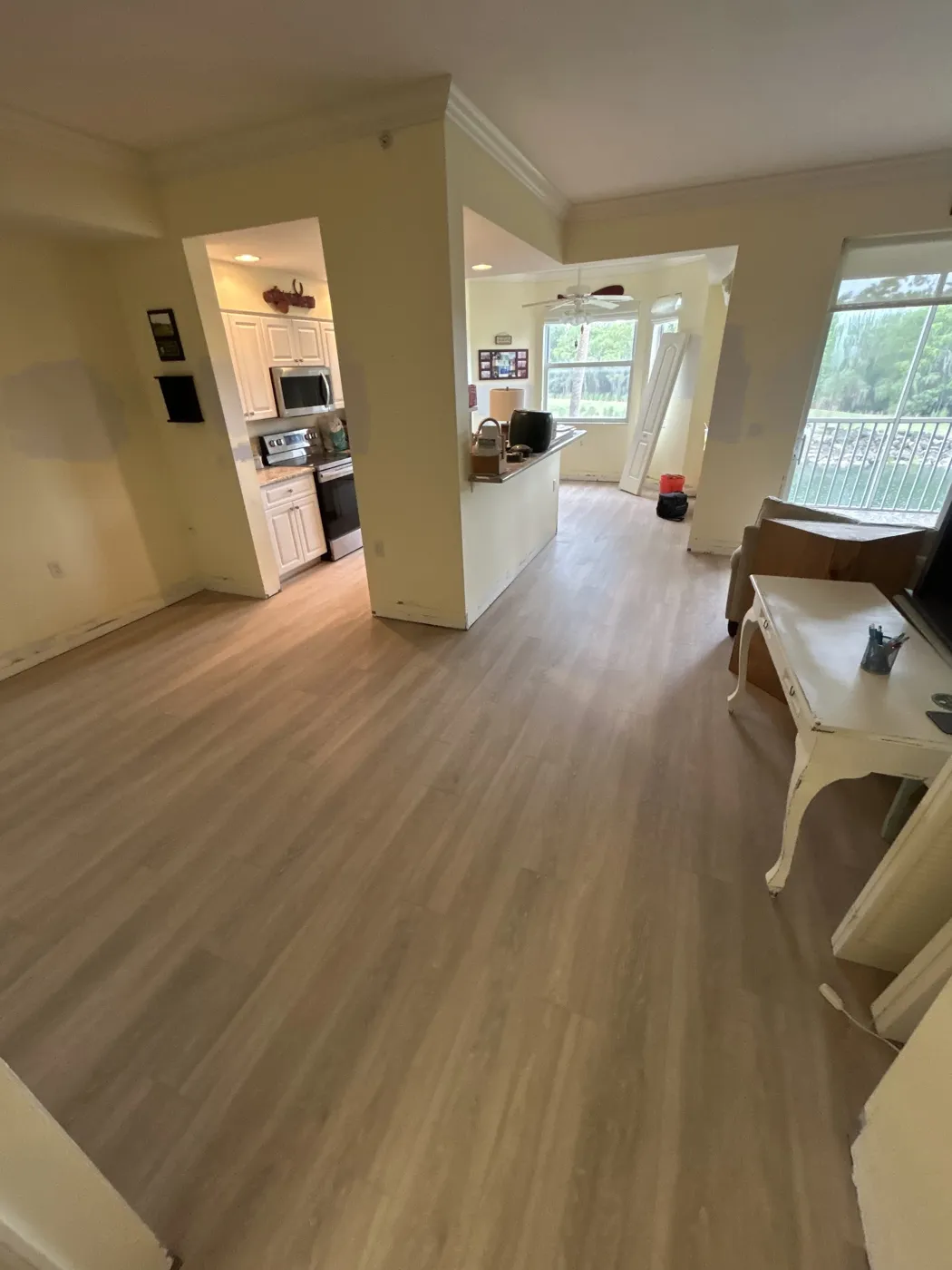 Luxury vinyl plank flooring through an open Naples kitchen and hallway