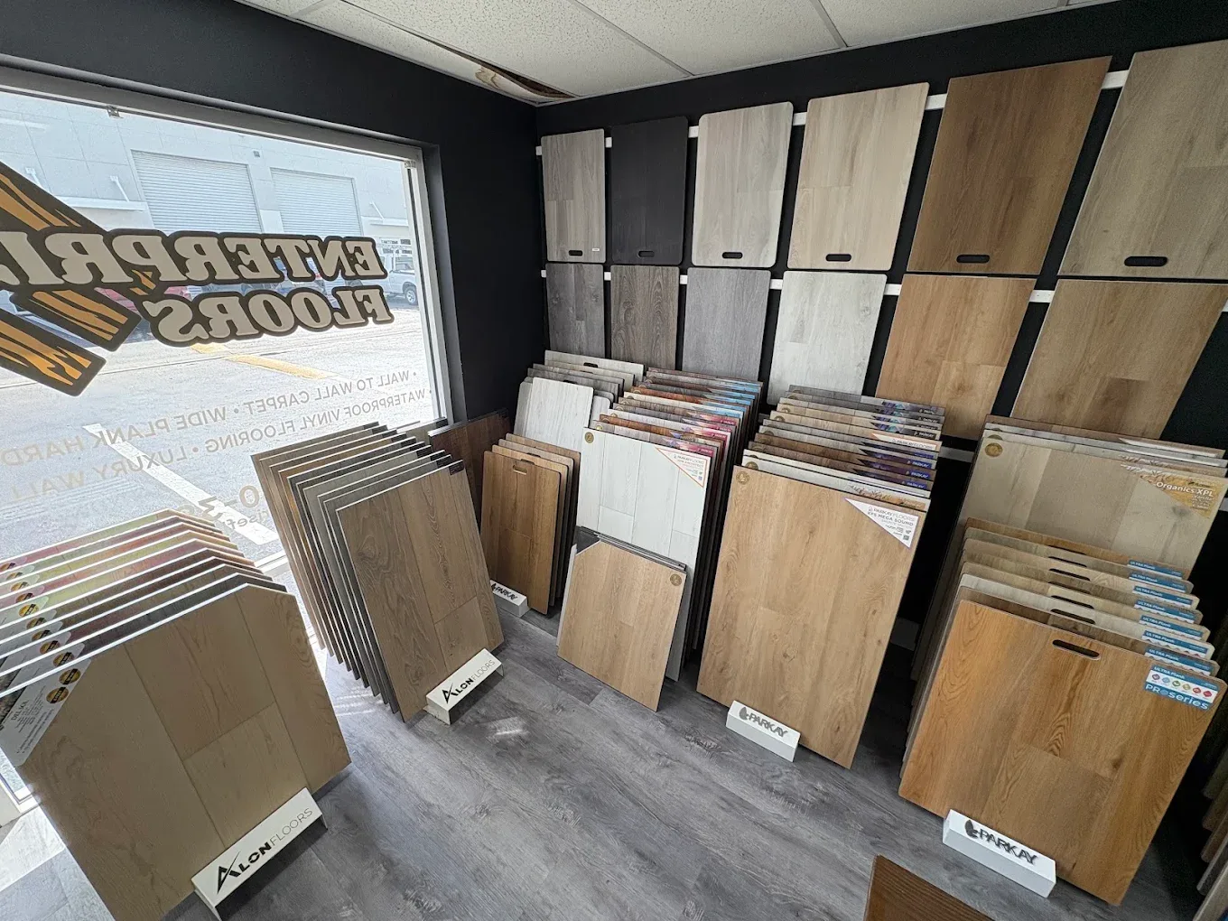 Enterprise Floors showroom display wall with vinyl and laminate plank samples