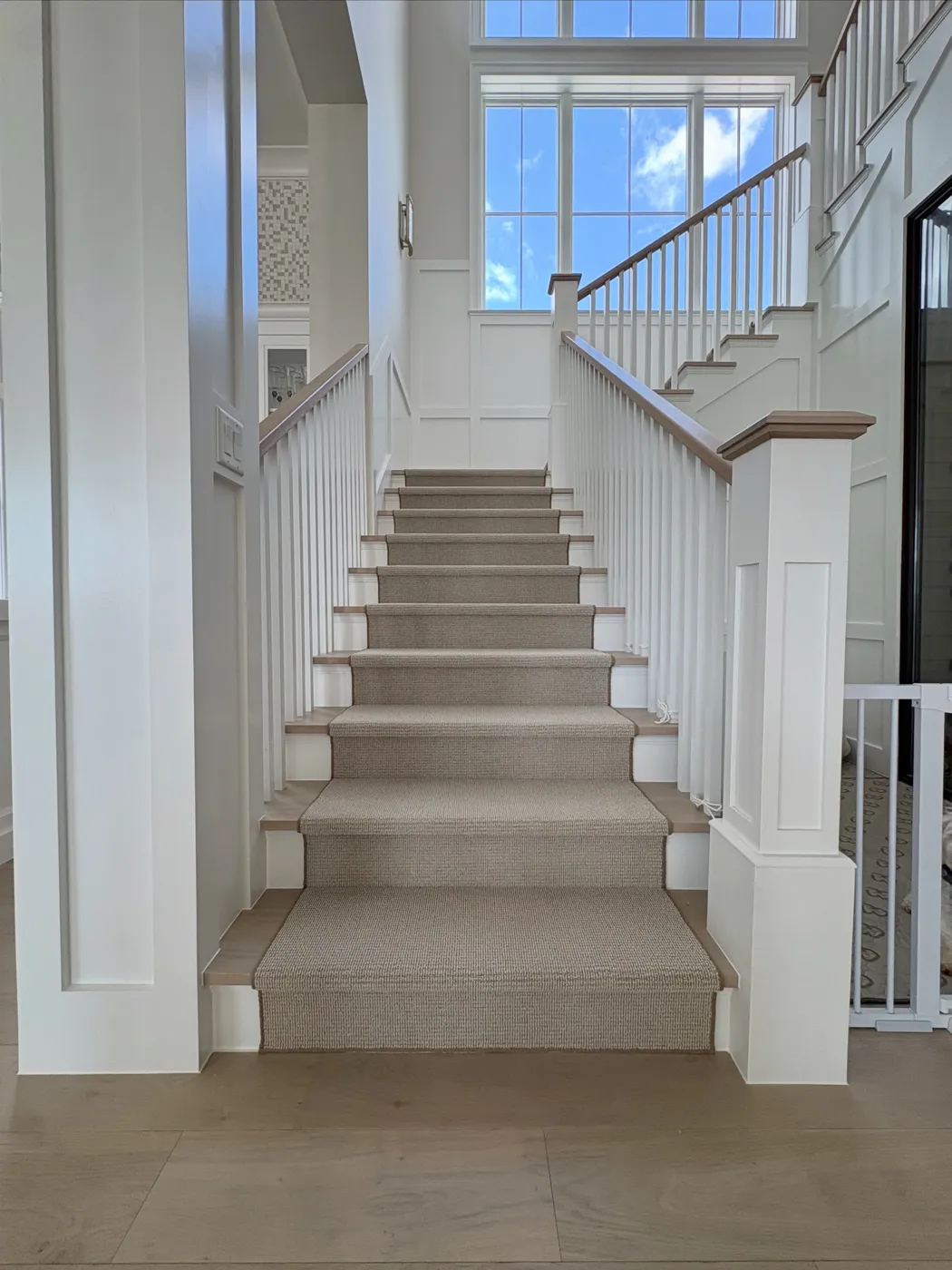 Custom-bound stair runner on a white Naples staircase